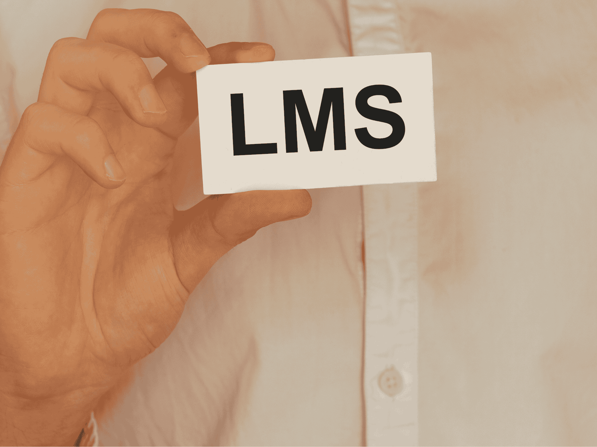 Workforce trainer holding a card with the letters "LMS"